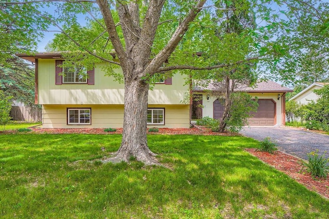 2108 Gunflint Trl, Brooklyn Park, MN 55444 - split level home with a garage, driveway, and a front lawn