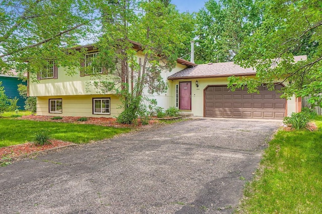 2108 Gunflint Trl, Brooklyn Park, MN 55444 - split level home featuring driveway, an attached garage, and a front yard