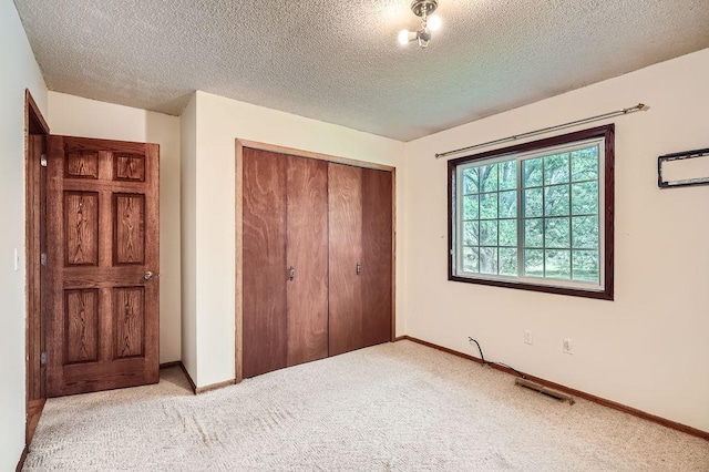 2108 Gunflint Trl, Brooklyn Park, MN 55444 - unfurnished bedroom featuring a closet, carpet floors, and a textured ceiling