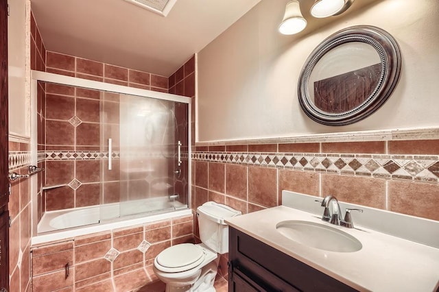 2108 Gunflint Trl, Brooklyn Park, MN 55444 - bathroom featuring tiled shower / bath, tile walls, and vanity
