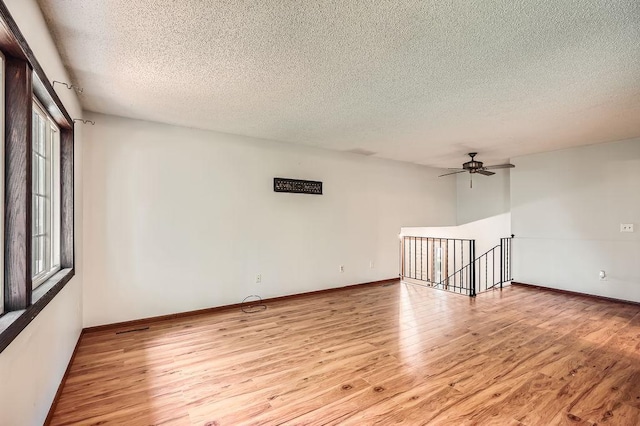 2108 Gunflint Trl, Brooklyn Park, MN 55444 - spare room with a textured ceiling, light wood-type flooring, and ceiling fan