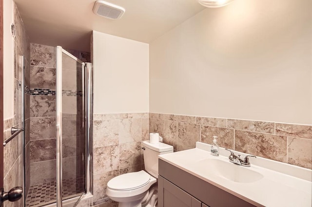 2108 Gunflint Trl, Brooklyn Park, MN 55444 - bathroom featuring vanity, a stall shower, wainscoting, and tile walls