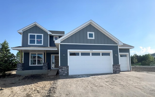 4424 Obsidian Way, Victoria, MN 55386 - craftsman inspired home featuring stone siding, a garage, board and batten siding, and dirt driveway