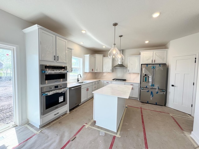 4424 Obsidian Way, Victoria, MN 55386 - kitchen featuring stainless steel appliances, a sink, light countertops, decorative light fixtures, and a kitchen island