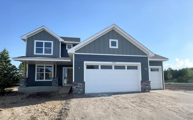 4424 Obsidian Way, Victoria, MN 55386 - craftsman-style home featuring stone siding, an attached garage, board and batten siding, and driveway
