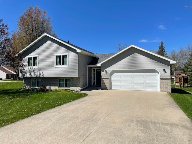 405 1st Ave SE, Grand Meadow, MN 55936 - tri-level home with a front lawn, concrete driveway, brick siding, and a garage