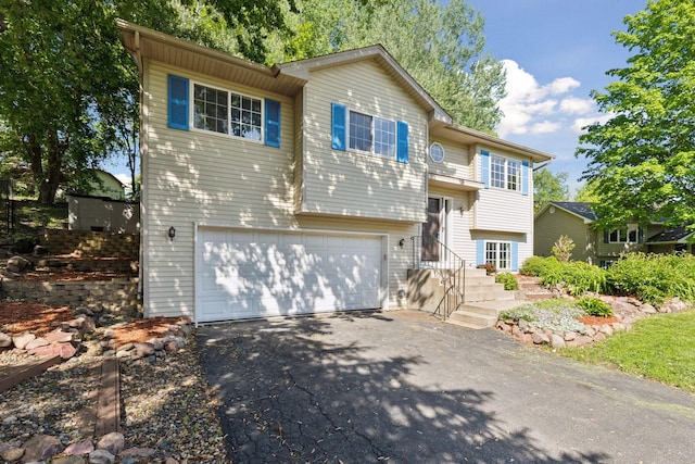 1604 Viking Dr, Buffalo, MN 55313 - bi-level home featuring asphalt driveway and an attached garage
