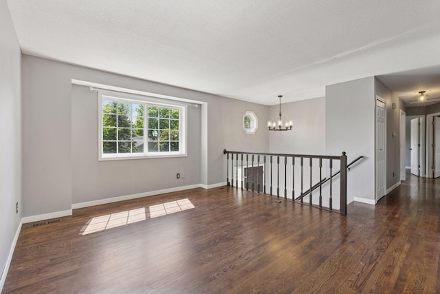 1604 Viking Dr, Buffalo, MN 55313 - empty room featuring a chandelier, wood finished floors, and baseboards