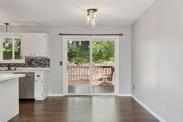 1604 Viking Dr, Buffalo, MN 55313 - kitchen featuring stainless steel dishwasher, light countertops, plenty of natural light, and white cabinetry