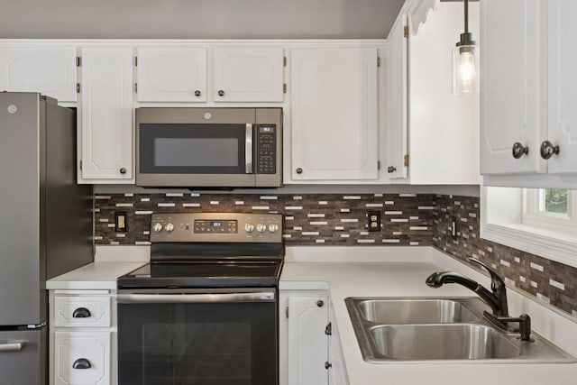 1604 Viking Dr, Buffalo, MN 55313 - kitchen featuring appliances with stainless steel finishes, a sink, light countertops, and white cabinetry