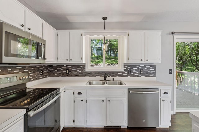 1604 Viking Dr, Buffalo, MN 55313 - kitchen with appliances with stainless steel finishes, a sink, light countertops, backsplash, and white cabinetry