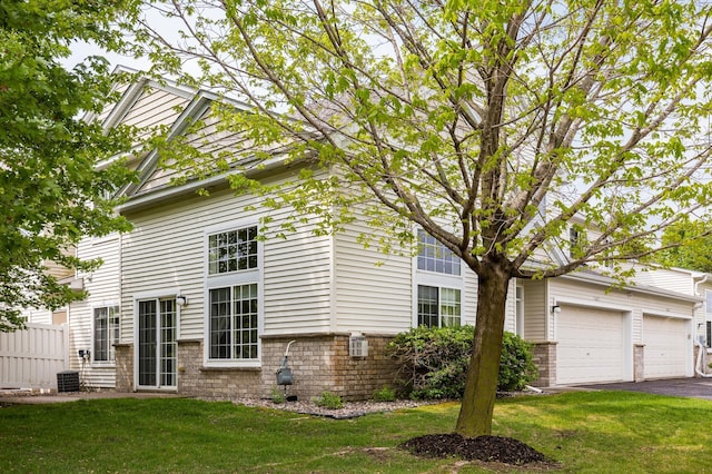 7625 Lachman Ave NE, Otsego, MN 55301 - view of side of home featuring asphalt driveway and brick siding
