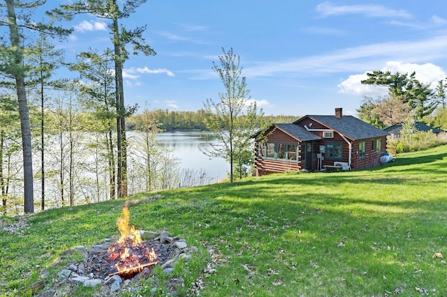1949 Little Blake Lake Ln, Georgetown Twp, WI 54853 - view of grassy yard with an outdoor fire pit and a water view