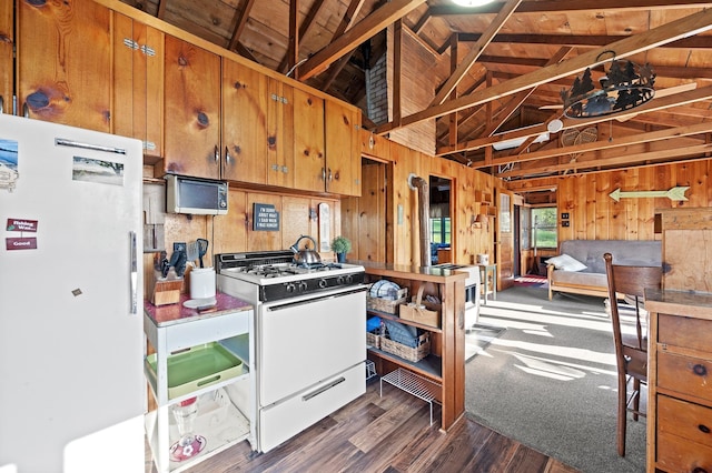1949 Little Blake Lake Ln, Georgetown Twp, WI 54853 - kitchen featuring white appliances, wood walls, brown cabinets, dark wood-style floors, and a wooden ceiling with exposed beams