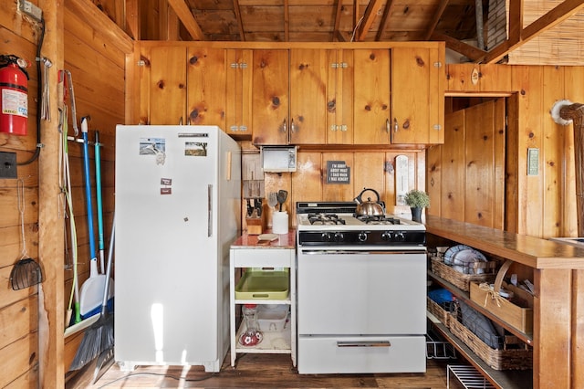 1949 Little Blake Lake Ln, Georgetown Twp, WI 54853 - kitchen with white appliances, wood finished floors, wood walls, brown cabinetry, and wooden ceiling