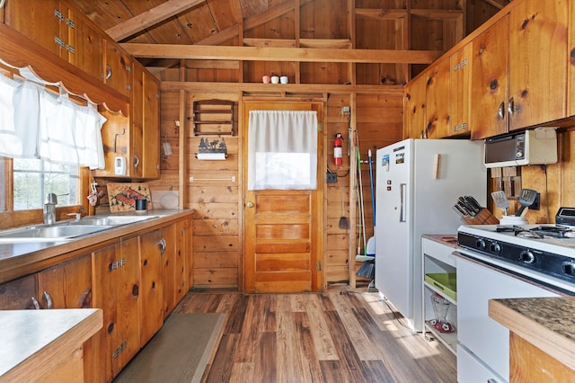 1949 Little Blake Lake Ln, Georgetown Twp, WI 54853 - kitchen with white gas range, wood walls, wood finished floors, wood ceiling, and brown cabinetry
