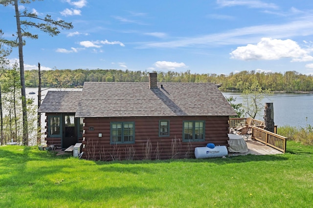 1949 Little Blake Lake Ln, Georgetown Twp, WI 54853 - back of property featuring log exterior, a deck with water view, roof with shingles, and a lawn