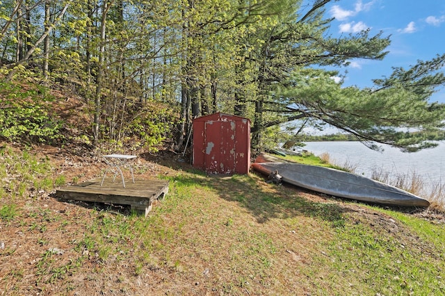 1949 Little Blake Lake Ln, Georgetown Twp, WI 54853 - view of grassy yard featuring a storage unit and a water view