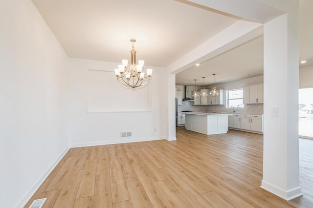 3112 Sugar Maple Dr, Chaska, MN 55318 - kitchen featuring a chandelier, light wood-type flooring, light countertops, and white cabinetry
