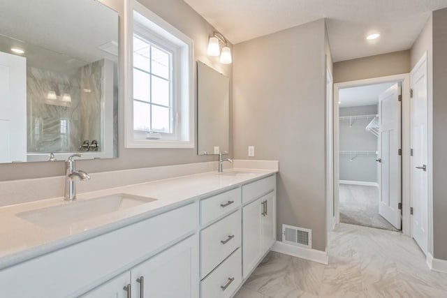 3112 Sugar Maple Dr, Chaska, MN 55318 - full bath with double vanity, marble finish flooring, baseboards, a walk in closet, and recessed lighting
