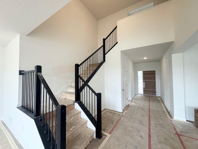 3112 Sugar Maple Dr, Chaska, MN 55318 - stairway featuring baseboards and a high ceiling