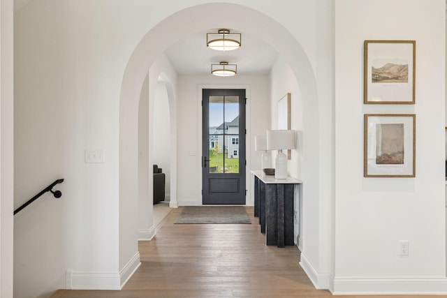 4612 Meadowview Ln, Minnetrista, MN 55331 - foyer entrance featuring light wood finished floors and arched walkways