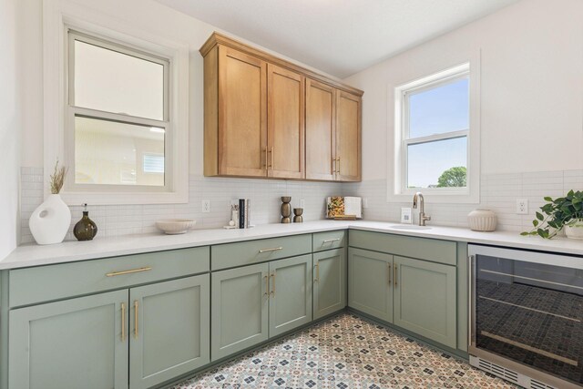 4612 Meadowview Ln, Minnetrista, MN 55331 - kitchen with beverage cooler, green cabinets, light countertops, and backsplash