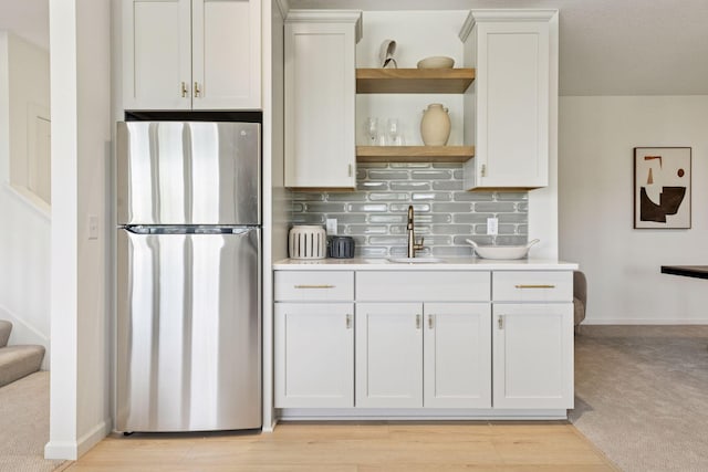 4612 Meadowview Ln, Minnetrista, MN 55331 - kitchen featuring freestanding refrigerator, open shelves, light countertops, tasteful backsplash, and light wood-style flooring