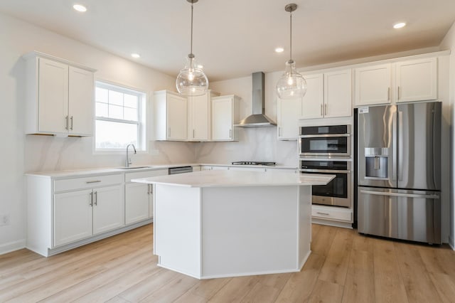 20092 67th Ave, Corcoran, MN 55340 - kitchen with appliances with stainless steel finishes, wall chimney range hood, a sink, light countertops, and white cabinetry