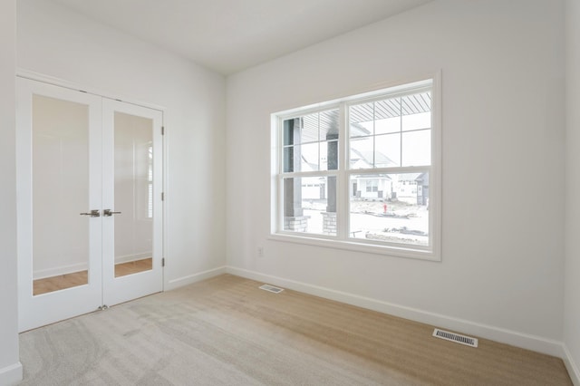 20092 67th Ave, Corcoran, MN 55340 - empty room featuring french doors, carpet, and baseboards