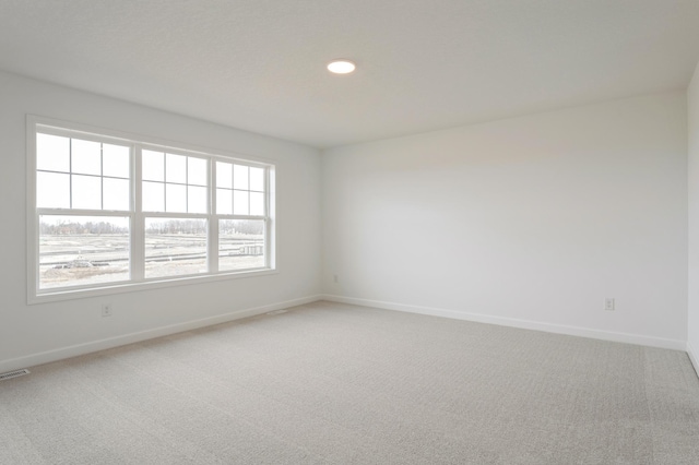 20092 67th Ave, Corcoran, MN 55340 - spare room featuring light carpet, baseboards, and recessed lighting