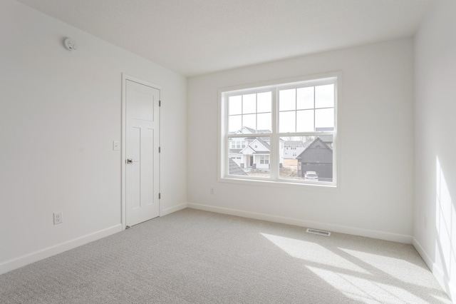 20092 67th Ave, Corcoran, MN 55340 - empty room featuring light colored carpet, baseboards, and a smoke detector