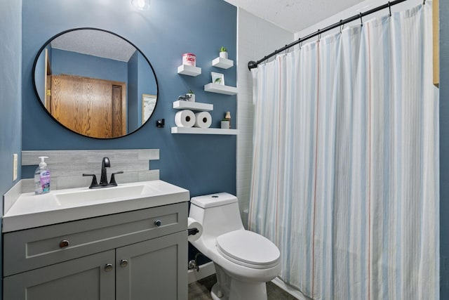 bathroom featuring a textured ceiling, toilet, vanity, and a shower with curtain