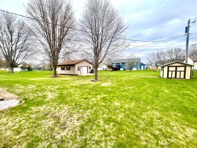 1112 10th St, Gaylord, MN 55334 - view of grassy yard featuring an outdoor structure and a storage unit