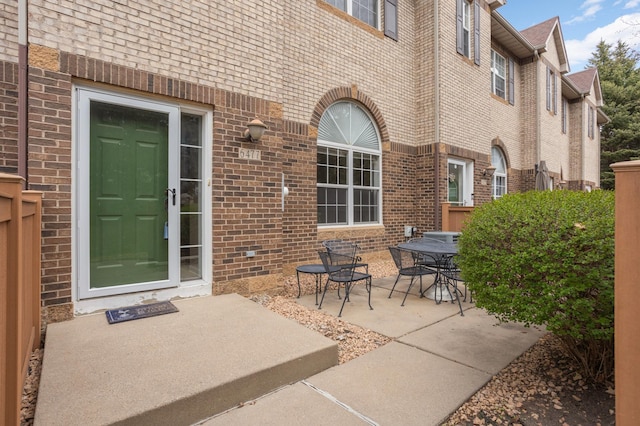 6477 Regency Ln, Eden Prairie, MN 55344 - entrance to property with a patio area, brick siding, and outdoor dining space