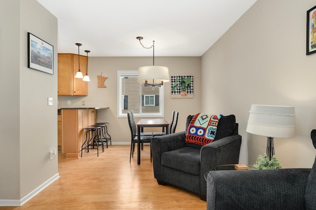 6477 Regency Ln, Eden Prairie, MN 55344 - living area with light wood-style floors, baseboards, and a chandelier