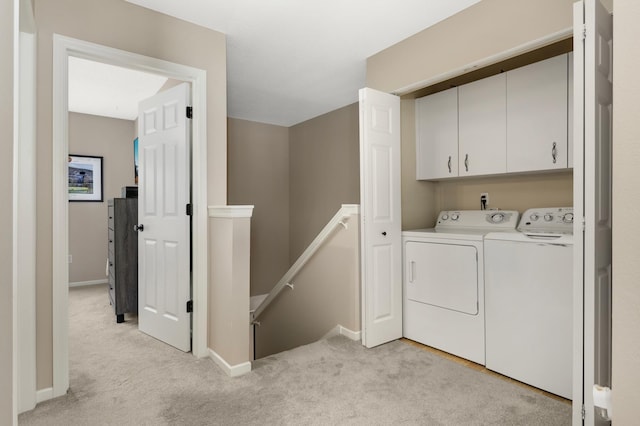 6477 Regency Ln, Eden Prairie, MN 55344 - washroom featuring washer and clothes dryer, cabinet space, light carpet, and baseboards