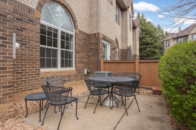 6477 Regency Ln, Eden Prairie, MN 55344 - view of patio featuring outdoor dining area and fence