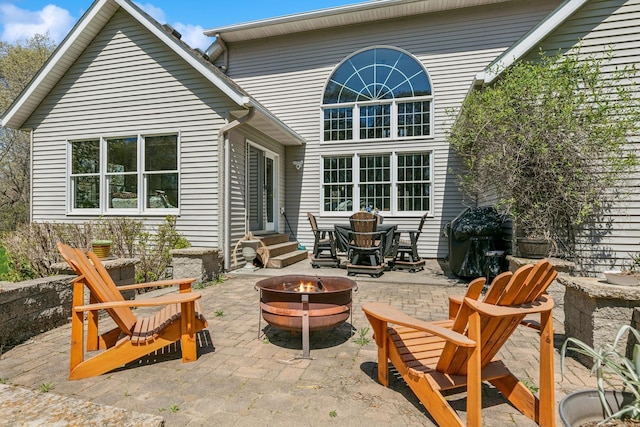 rear view of house featuring an outdoor fire pit, a patio, and entry steps