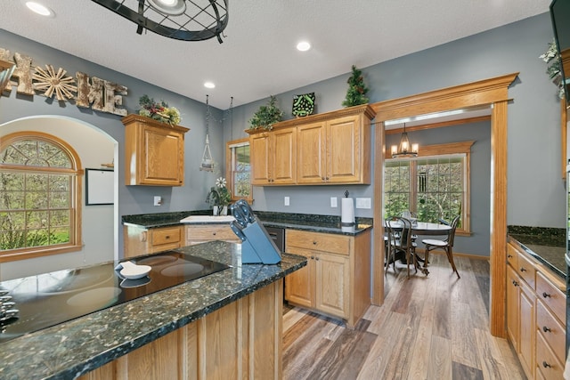 kitchen with light wood finished floors, black electric cooktop, a chandelier, a textured ceiling, and recessed lighting