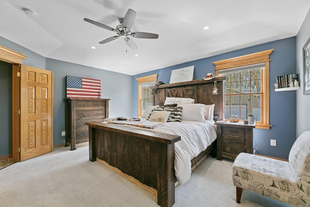 bedroom featuring multiple windows, light colored carpet, baseboards, a ceiling fan, and recessed lighting