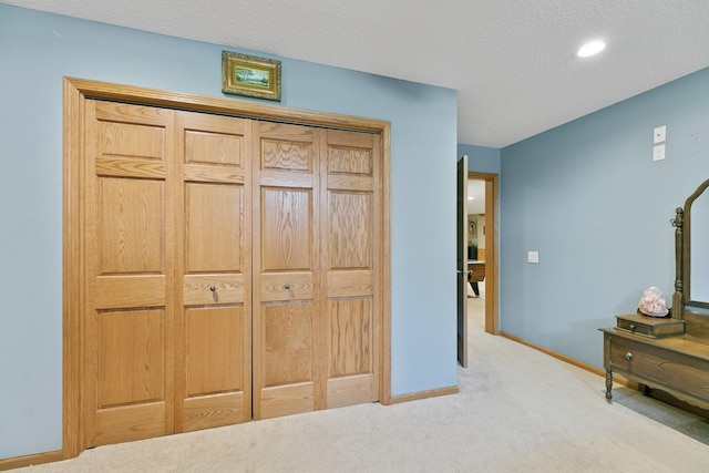 carpeted bedroom featuring baseboards and recessed lighting