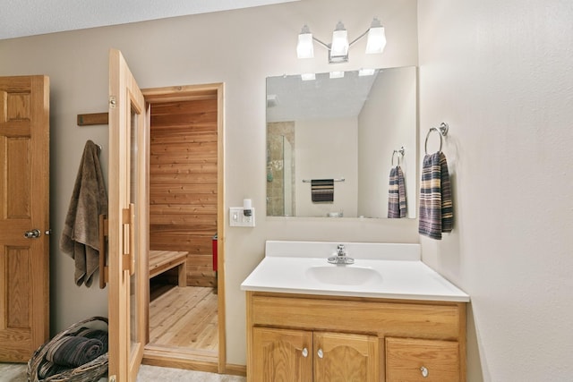 full bathroom featuring a stall shower and vanity