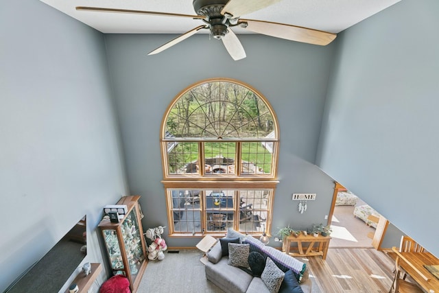 living room with a high ceiling and a ceiling fan