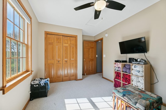 carpeted bedroom with multiple windows, baseboards, and a closet