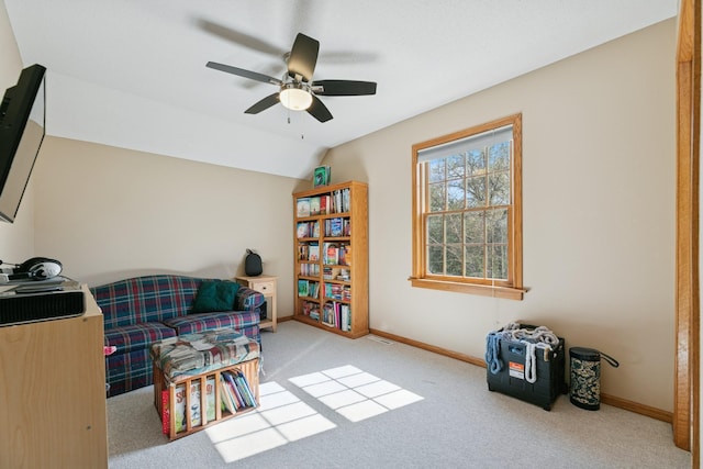 sitting room with carpet flooring, a ceiling fan, baseboards, and lofted ceiling