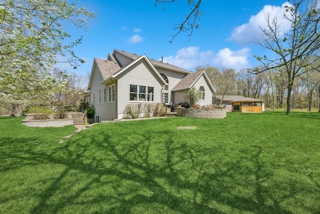 back of property featuring a lawn and an attached garage