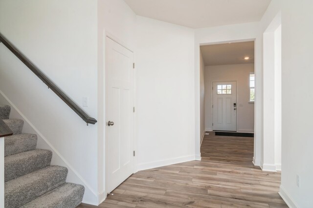 7576 Norway Ln, Lino Lakes, MN 55038 - hall featuring stairway, light wood finished floors, and baseboards