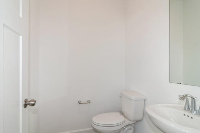 7576 Norway Ln, Lino Lakes, MN 55038 - bathroom with a sink, toilet, and baseboards