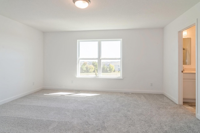 7576 Norway Ln, Lino Lakes, MN 55038 - carpeted empty room featuring baseboards and a sink